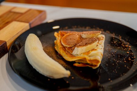 Photo for Banana on a pancake, a sweet nutritious snack or breakfast - Royalty Free Image