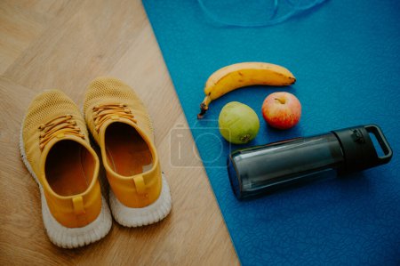 Photo for A mix of berries and a protein shake positioned on a fitness mat. Fueling up for a vigorous workout routine. - Royalty Free Image