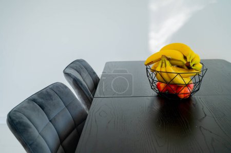 Natural light graces a glass bowl with a banana on the kitchen counter