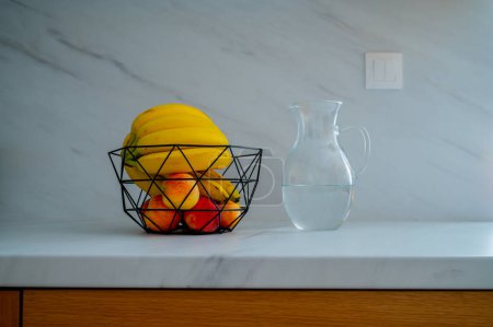 Photo for A banana in a glass bowl captures the essence of daylight on the kitchen counter - Royalty Free Image