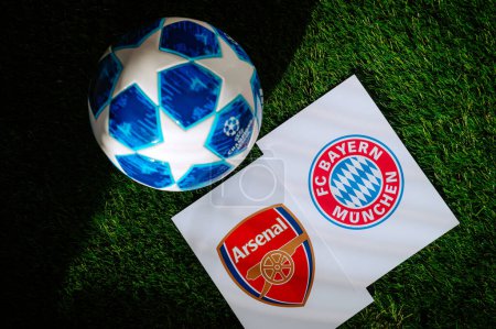 Photo for PARIS, FRANCE, MARCH. 16. 2024: Arsenal F.C. (ENG) vs. Bayern Munich (GER. Quarter Finals of football UEFA Champions League 2024 in Europe. Logo of teams and official soccer ball on green grass - Royalty Free Image