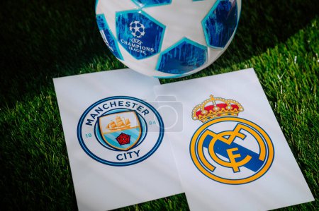 Photo for PARIS, FRANCE, MARCH. 16. 2024: Real Madrid (ESP) vs Manchester City (ENG) Quarter Final of football UEFA Champions League 2024 in Europe. Logo of the teams and official soccer ball on green grass - Royalty Free Image