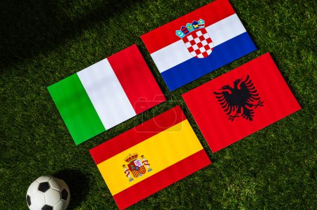 Spain Heads Group B: Flags of Spain, Croatia, Italy, Albania, and soccer ball on green grass at Europe football tournament in Germany in 2024