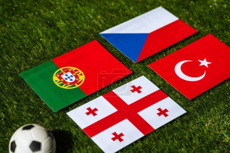 Photo for Turkey, Georgia, Portugal, Czech Republic nationals flag and football ball on green grass. Group F at summer tournament 2024 in Germany - Royalty Free Image