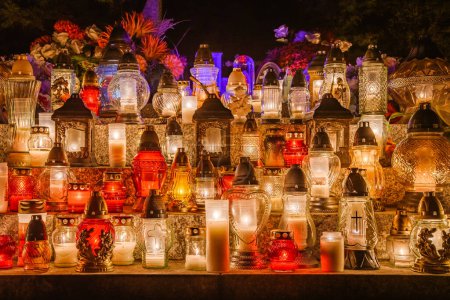 Lighted colorful candles on the feast of the dead, set on the grave of the memory of the deceased.