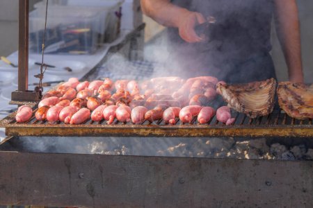 Street food, meat tasty grilled sausages, cooking on charcoal in the outdoors