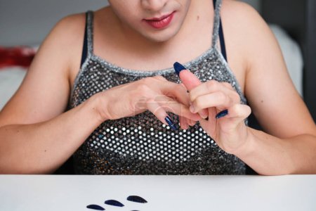 Photo for Young unrecognizable drag queen removing glitter false nails. - Royalty Free Image