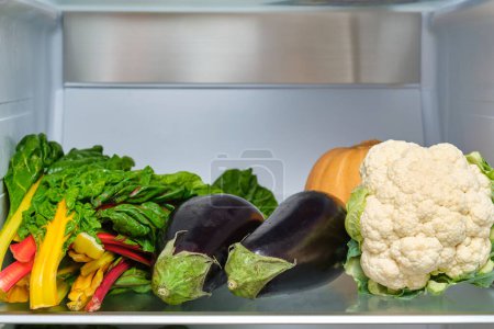 Photo for Bunch of rainbow swiss chard, cauliflower, squash, eggplant in the fridge. Fresh vegetables. - Royalty Free Image