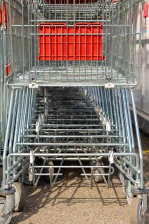 shopping cart in front of supermarket with view from below in selective focus