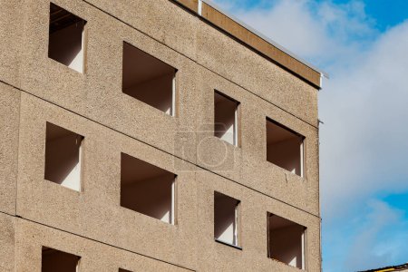 an empty gdr apartment block with blue sky in the background