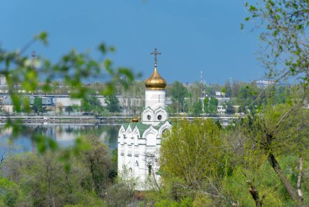 Photo for Church with golden domes and place religion of orthodox christian. Beautiful landscape with green park in middle of river. View of monastyrsky island with church of saint Nicholas in Dnipro Ukraine. - Royalty Free Image