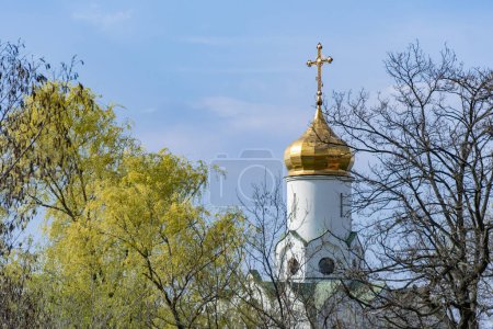 Photo for Church saint Nicholas with golden domes and place religion of orthodox christian. Built structure for prayer in modern city. Landscape with green park in middle of river. Monastyrsky island in Dnipro. - Royalty Free Image