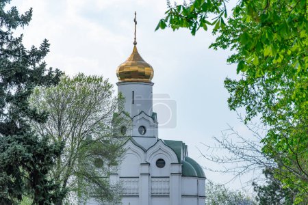 Photo for Church saint Nicholas with golden domes and place religion of orthodox christian. Built structure for prayer in modern city. Landscape with green park in middle of river. Monastyrsky island in Dnipro. - Royalty Free Image