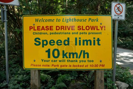 Photo for West Vancouver, Canada -May 20,2023: View of Warning sign Please drive slowly inside the Lighthouse Park in West Vancouver - Royalty Free Image