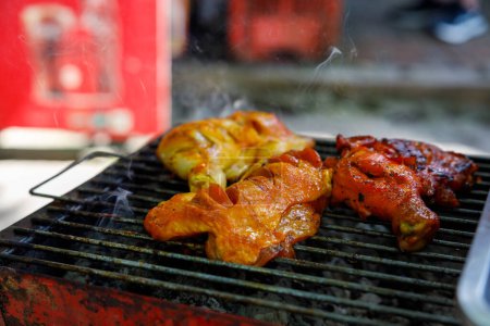Hot chicken grilled on one of the streets of Koh Samui, Thailand