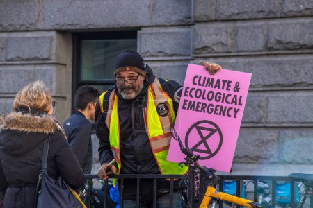 Photo for Vancouver, Canada - October 25,2019: A man with the sign Climate and Ecological Emergency as part of Climate Strike in front of Vancouver Art Gallery - Royalty Free Image