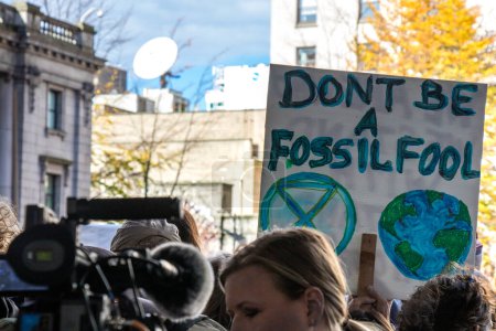 Photo for Vancouver, Canada - October 25,2019: A man with the sign Dont be a fossil fool as part of the climate strike in front of Vancouver Art Gallery - Royalty Free Image