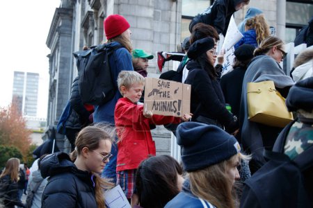 Photo for Vancouver, Canada - October 25,2019: A little boy with the sign Save the Animals as part of Climate Strike in front of Vancouver Art Gallery - Royalty Free Image