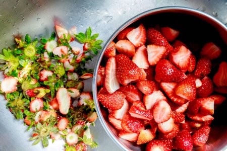 Photo for Fresh strawberries are cleaned and cut into pieces - Royalty Free Image
