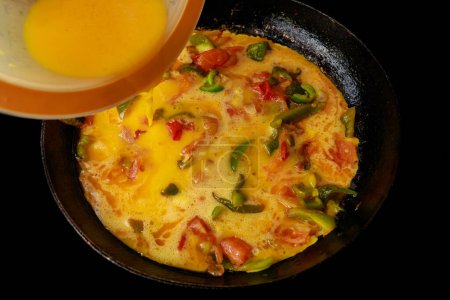 Beaten eggs and vegetables are used to make this frittata.