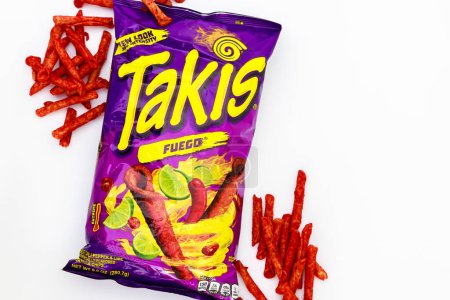 Photo for February 3, 2023. Spartanburg, SC USA. Rolling tortilla chips with chili peppers and lime by Takis Fuego - Royalty Free Image