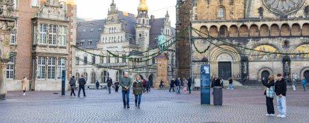 Photo for Bremen, Germany - Novemeber 13, 2022: Tourist passing the central market square near townhall in Bremen in state Free Hanseatic City of Bremen in Germany - Royalty Free Image