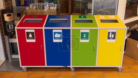 Photo for Aarhus, Denmark - November 16, 2022: Seperating waste in different colorful waste bins with Danish text for plastic packaging, food, paper and carton and residual waste - Royalty Free Image