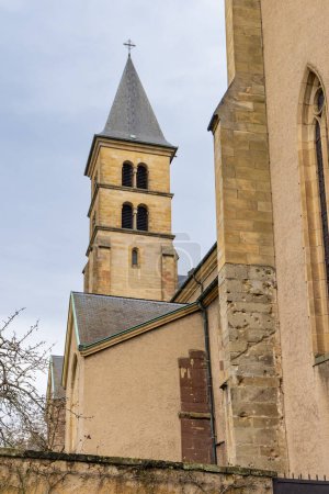 Foto de Cityscape of Echternach with church Saint Peter and Sain Paul and sculpture in oldest town in Luxembourg. Near Mullerthal. - Imagen libre de derechos