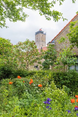 Photo for Lighthouse Brandaris in West-Terschelling with flowers in front at Wadden island Terschelling in Friesland province in The Netherlands - Royalty Free Image