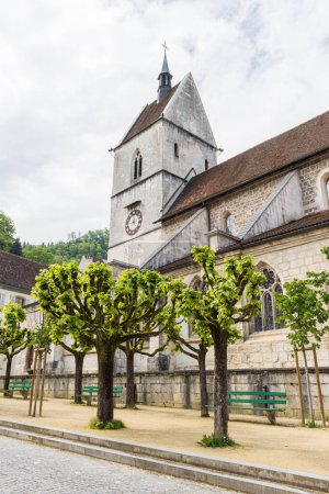 Téléchargez les photos : Paysage urbain avec porte d'entrée de l'église du village pittoresque Saint-Ursanne dans le canton du Jura quartier Porrentruy en Suisse - en image libre de droit