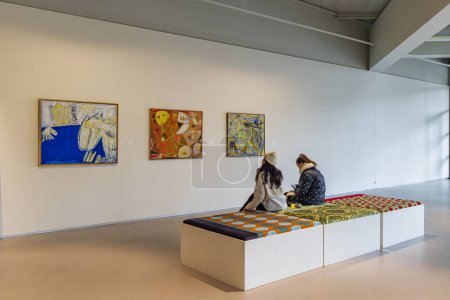 Téléchargez les photos : Amstelveen, Pays-Bas - 21 janvier 2024 : Visiteurs regardant trois tableaux Cobra dans la salle d'exposition du Cobra Museum of modern art à Amstelveen, Pays-Bas - en image libre de droit