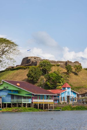 Scenic view of colorful church and fortress of El Castillo village along the San Juan river in Nicaragua