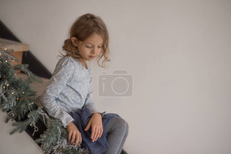 Photo for Child happiness with present in room and sits on the stairs. High quality photo - Royalty Free Image