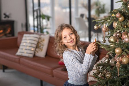 Photo for Child happiness with present in room and x-mas tree and gingerbread horse. High quality photo - Royalty Free Image