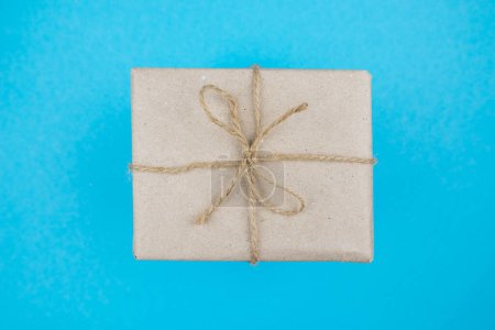 Photo for Top view photo of kraft paper gift box on blue background - Royalty Free Image