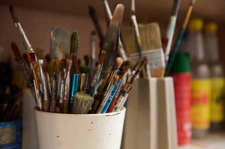 Horizontal photography of oil paintbrushes in creative art studio or workshop. Artist's brushes. Painting. Art class. Education.