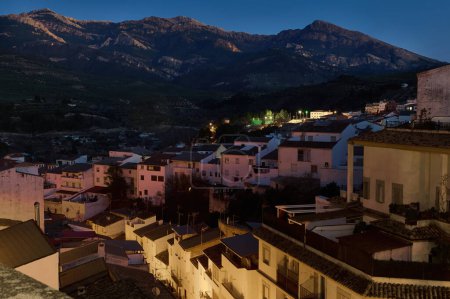 Photo for Quesada by night - beautiful medieval and historic city in province of Jaen in Andalusia, Spain. Tourism and Travel concept. White buildings and houses illuminated by street lighting in the night time - Royalty Free Image