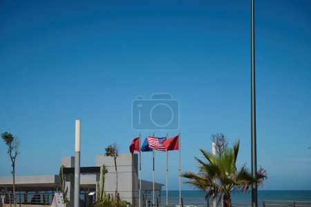 Photo for Background with flags of different countries - Moroccan, Spanish, European Union, USA and Great Britain flags over blue sky background - Royalty Free Image