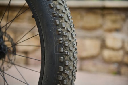 Details on tubeless tire of an electric motor bike, mountain bike. Shallow tread of a bicycle tubeless tire. Cropped view of electric bike bicycle wheel with spokes. Copy advertising space