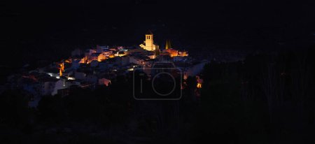 Photo for View from the hill of medieval historical village of Quesada in province of Jaen, with the illuminated bell tower and while houses in the night time. Beauty in Spain nature. Travel and tourism concept - Royalty Free Image