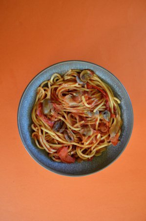 Photo for Spaghetti and vegetables with tomato passata in a bowl on the table - Royalty Free Image