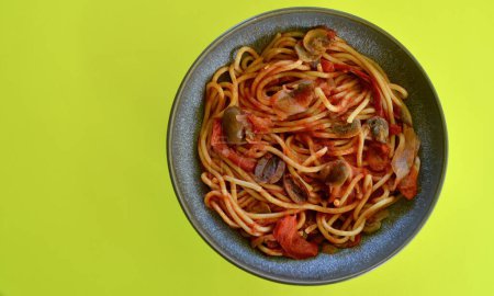 Photo for Spaghetti and vegetables with tomato passata in a bowl on the table - Royalty Free Image