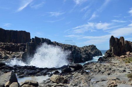 A view of waves crashing against rock formations at Bombo on the South Coast of New South Wales, Australia