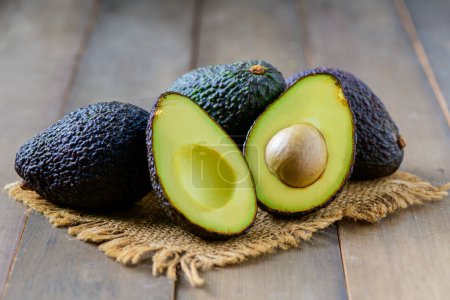 Fresh avocado on wood background, High in vitamins and minerals such as vitamin B helps prevent beriberi, vitamin C helps strengthen the immune system