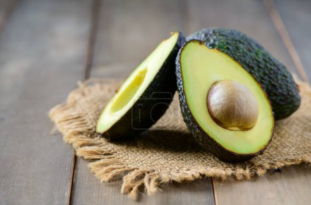 Fresh avocado on wood background, High in vitamins and minerals such as vitamin B helps prevent beriberi, vitamin C helps strengthen the immune system