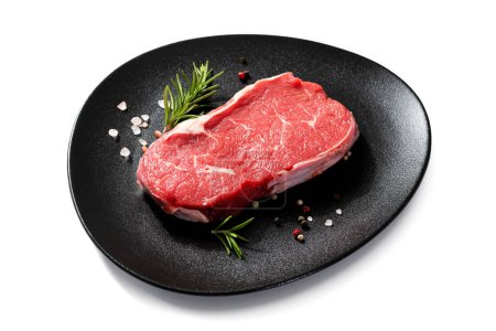 Téléchargez les photos : Steak de bœuf cru frais avec épices isolé sur fond blanc - en image libre de droit