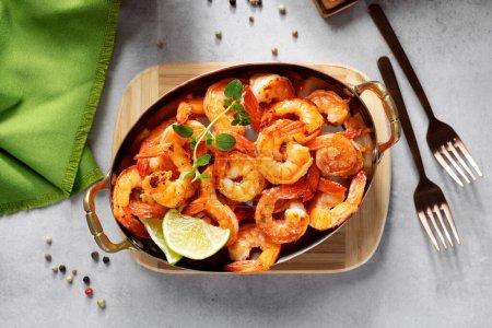 Grilled fresh Spicy  Prawns Shrimps with lime and oregano in serving pan. top view