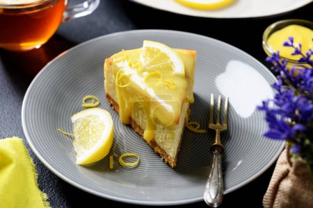 Foto de Rebanada de pastel de limón casero recién horneado con cuajada de limón y rodajas de limón. - Imagen libre de derechos
