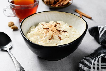 Fresh prepared rice pudding garnished with cinnamon flakes. Healthy breakfast for every day.