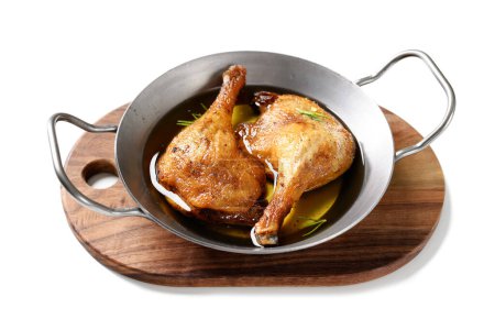 Photo for Freshly roasted duck legs confit in pan, isolated on white background. - Royalty Free Image